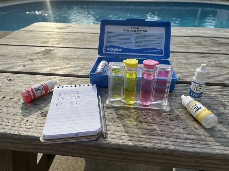 Taylor K-2006 pool test kit with pH and chlorine reagent tubes filled with sample water